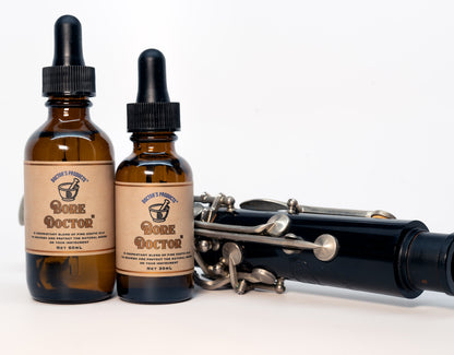 Bore Doctor 60 ml and 30 ml product shot next to clarinet